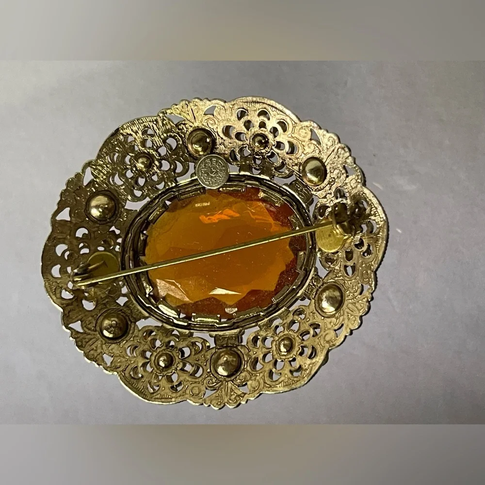 Vintage West Germany brooch featuring a large amber topaz glass filigree gold